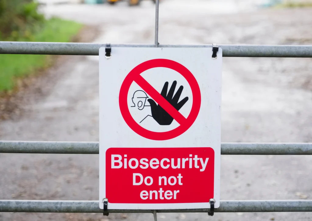 Australia Biosecurity Costs: What Alibaba Buyers Must Budget for Clearance 1 A warning sign on a metal fence reading "Biosecurity Do not enter" with a red prohibition symbol, representing Australia's strict biosecurity access controls.