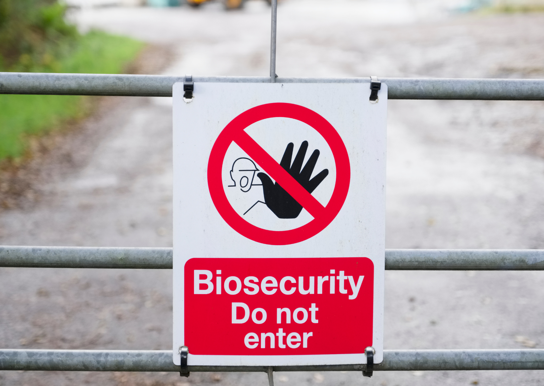 A warning sign on a metal fence reading "Biosecurity Do not enter" with a red prohibition symbol, representing Australia's strict biosecurity access controls.